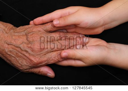 Young hands tending to an elderly person