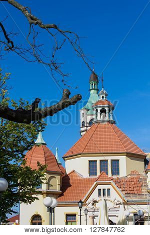 SOPOT POLAND - JUNE 6: Fragment of historic building of balneology Department and old lighthouse in Sopot Poland on June 6 2015