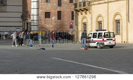 SIENA ITALY - CIRCA APRIL 2016: Polizia muncipale (i.e. Town Police) seizing football ball of Italian schoolboys playing in the Cathedral square