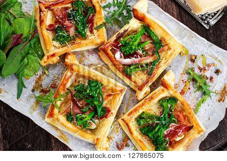 Bacon, soft cheese and tenderstem broccoli tips puff pastry tarts with green salad.