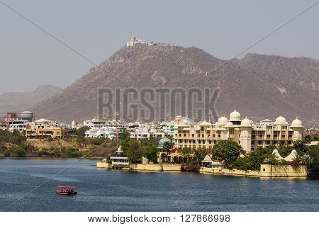UDAIPUR INDIA - 21ST MARCH 2016: A view towards the The Leela Palace and Monsoon Palace in Udaipur during the day.