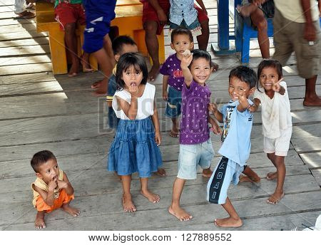 Indonesian Children On The Pier In Tobil Village Togean Islands