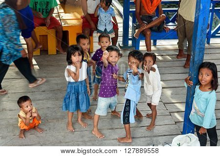 Indonesian Children On The Pier In Tobil Village Togean Islands