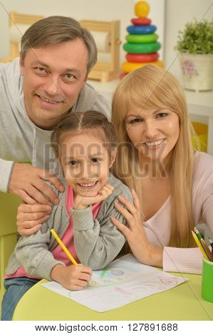 Portrait of happy family painting at home