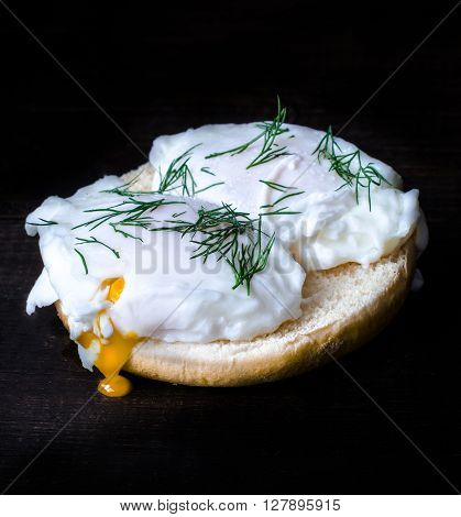 Eggburger with poached eggs for brackfast, moody photo style