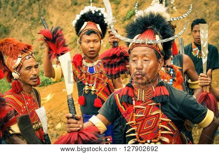 Mon Nagaland - April 2012: People in traditional costumes and large hats dance at Aoleang festival in Mon Nagaland. At this festival people can see indigenous dances and games and hear traditional songs. Documentary editorial.