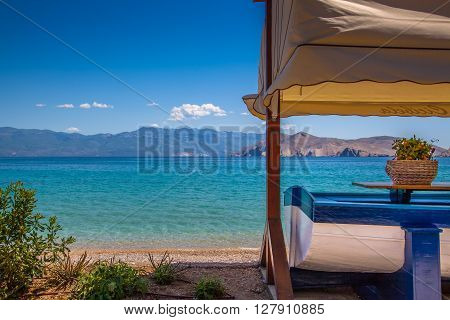A boat used as a table in front of a suny tropical beach