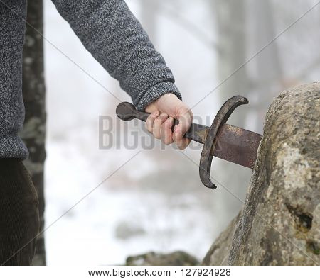 Knight Tries To Remove Excalibur Sword In The Stone