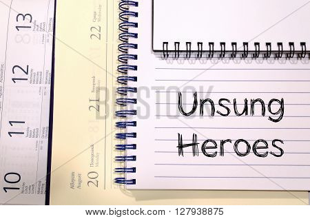 Unsung heroes text concept write on notebook