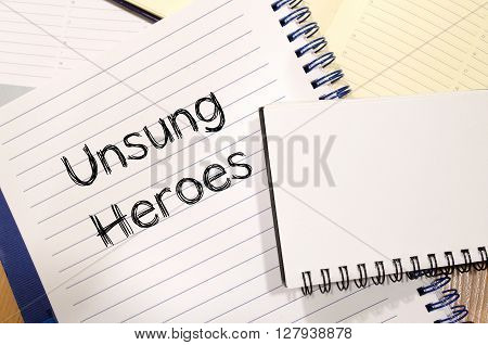 Unsung heroes text concept write on notebook