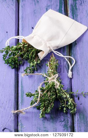 Thyme On Violet Wooden Table