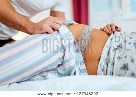Happy couple in bedroom enjoying sensual foreplay