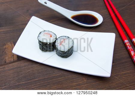 Maki with surimi on a wooden table seen up close