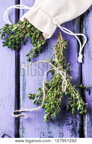 Thyme On Violet Wooden Table