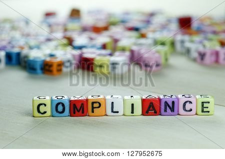 Close up of Compliance word on colorful Dices