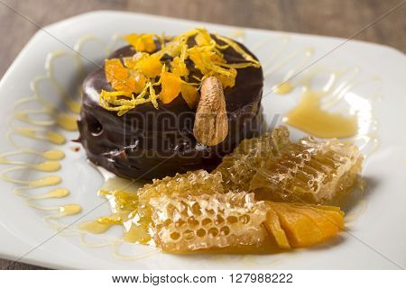 Lebkuchen With Pieces Of Apricot Above It In A Plate And Chocolates And A Piece Of Honeycomb Over A