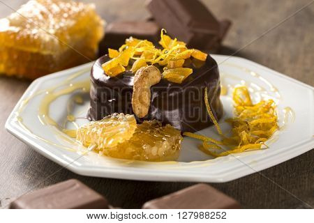 Lebkuchen With Pieces Of Apricot Above It In A Plate And Chocolates And A Piece Of Honeycomb Over A