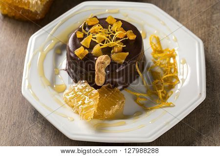 Lebkuchen With Pieces Of Apricot Above It In A Plate And Chocolates And A Piece Of Honeycomb Over A