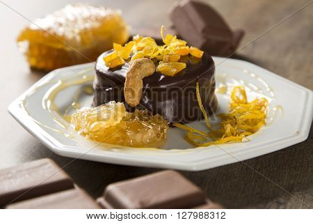 Lebkuchen With Pieces Of Apricot Above It In A Plate And Chocolates And A Piece Of Honeycomb Over A