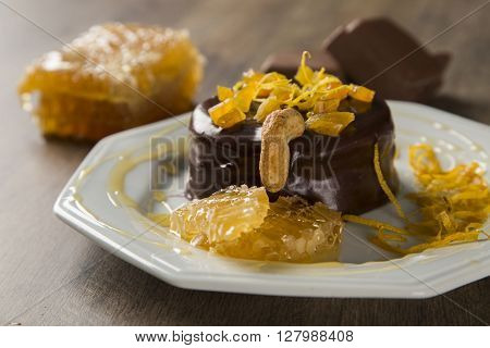 Lebkuchen With Pieces Of Apricot Above It In A Plate And Chocolates And A Piece Of Honeycomb Over A