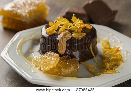 Lebkuchen With Pieces Of Apricot Above It In A Plate And Chocolates And A Piece Of Honeycomb Over A