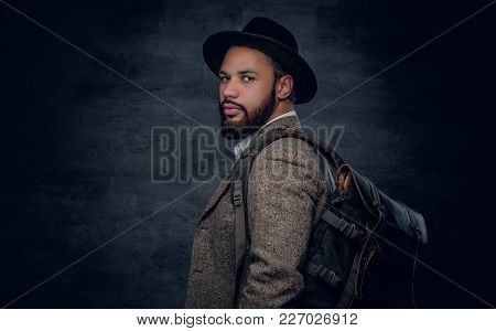 Bearded Black Man  Wearing A Wool Suit And A Felt Hat Holds Backpack.