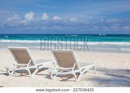 Two White Beach Chairs On The Empty Beach In Play Del Carmen, Yucatan, Mexico