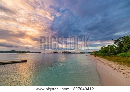Tropical Beach, Caribbean Sea, Canoe Floating On Transparent Turquoise Water, Remote Togean Islands 