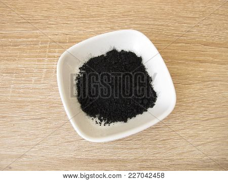 Black Ground Activated Carbon In White Bowl