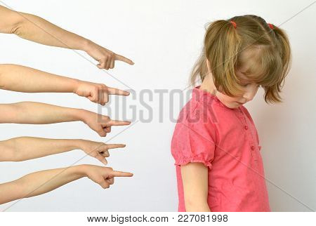many hands are pointing fingers at the child ,kid of the outcast conceptual photography