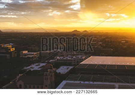 Panoramic View Of Phoenix, Arizona, Skyline At Sunrise. Camelback Mountain In The Distance.