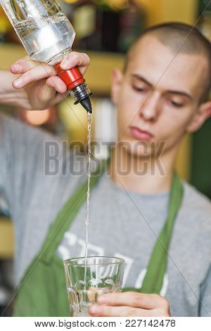 Young Bartender Making A Cocktail, Pouring Alcohol In A Cocktail Glass