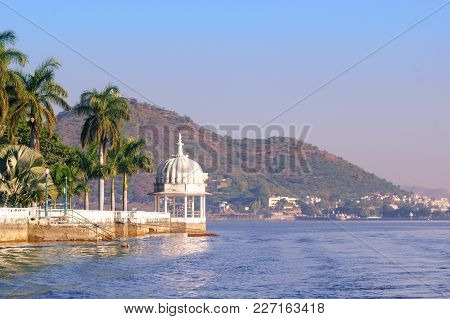 Nehru Island On Fateh Sagar Lake In Udaipur India. The White Domes And Trees Of The Island Are Visib