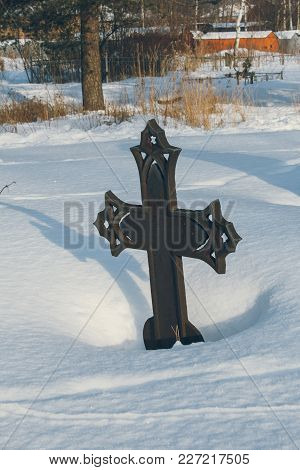 Image Of A Cast-iron Cross On An Abandoned Grave In The Old Cemetery In Winter