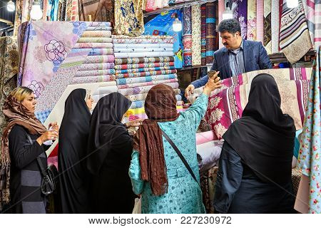 Tehran, Iran - April 29, 2017: Islamic Women Dressed In Religious Veil  Chooses Fabric In Tehran Gra