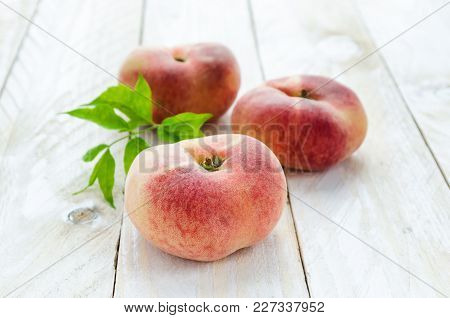 Saturn Peaches Or Ufo, Donut, Flat Peaches On White Wood Boards