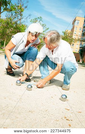 Senior Couple Playing A Game Of Boule