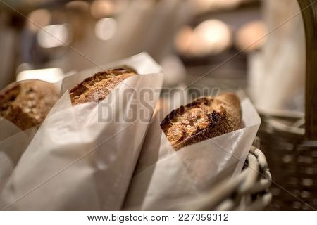 French Bread Baguettes In Paper Bags From Bakery. Selective Focus