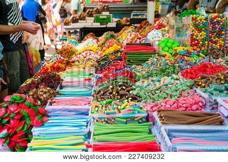 Customers Choose Sweets From Counter With Assorted Colorful Different Shape Jelly Candies On Market 