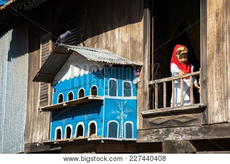 An Giang, Vietnam - Sep 6, 2016: Champa House Windows With Vietnamese Muslim Girl And Pigeon House I