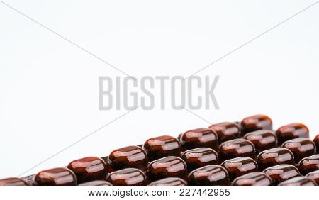 Tablets Pills Medicine In Light Resistant Blister Pack On White Background With Copy Space . Vitamin