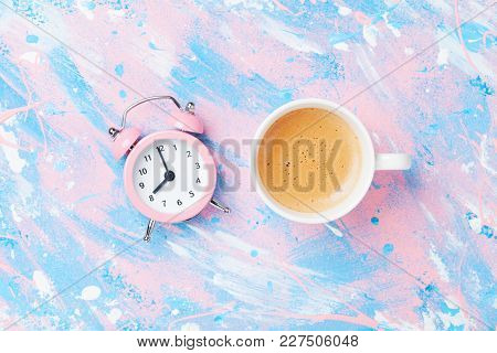 Morning Cup Of Coffee And Alarm Clock On Colorful Working Desk Top View In Flat Lay Style. Punchy Pa