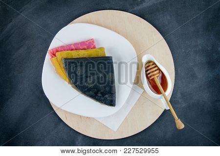 Colored Pancakes With Honey, Top View, Black Background