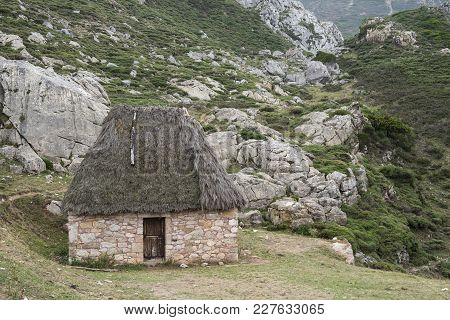 Traditional Stone Huts With Thatched Roof In Saliencia Valley, Somiedo Nature Reserve. It Is Located