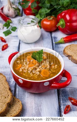 Traditional Spicy Soup With Rice And Vegetables In A Plate On The Table. Selective Focus.