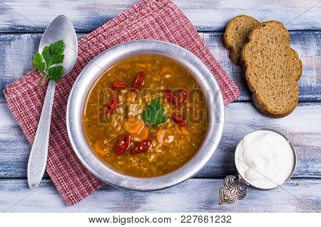 Traditional Spicy Soup With Rice And Vegetables In A Plate On The Table. Selective Focus.