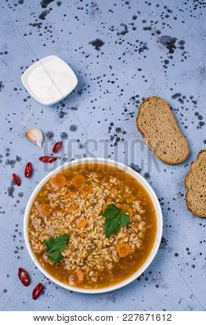 Traditional Spicy Soup With Rice And Vegetables In A Plate On The Table. Selective Focus.