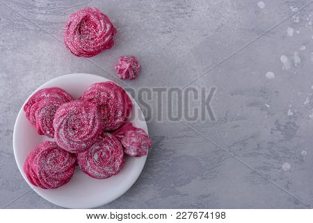 Tasty Meringues Cookies On Plate And Gray Background