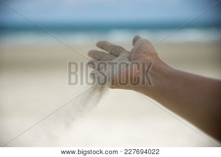Freedom,release And Wellness Concept.hand Of Woman Release Sand With Seabeach Background