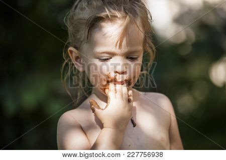 Little Beautiful Blonde Girl Looking Odonata Bug Flying Over Grass Field On A Sunny Summer Day.